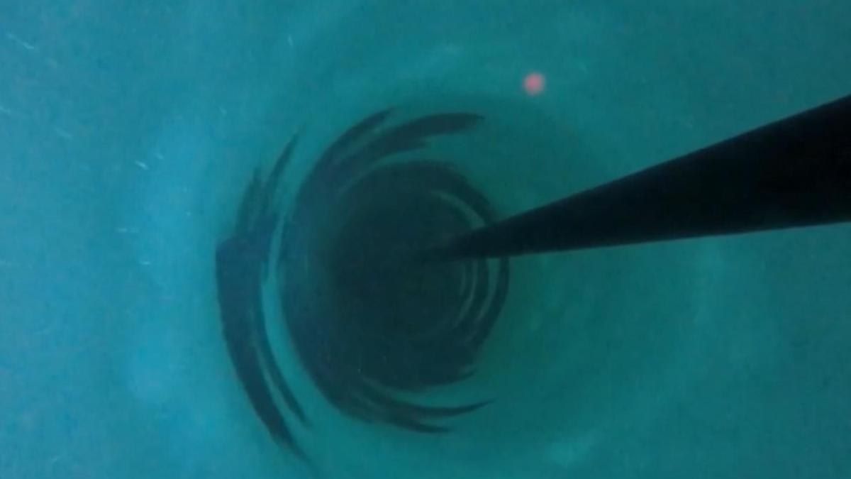 ** Drilling equipment on Antarctic ice sheet with snow-covered mountains in background