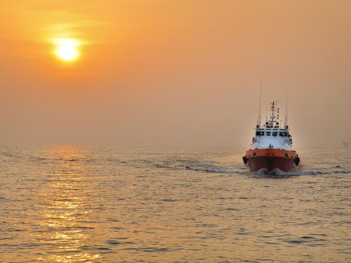 Rescue boat on water near capsized vessel in river during emergency response operation