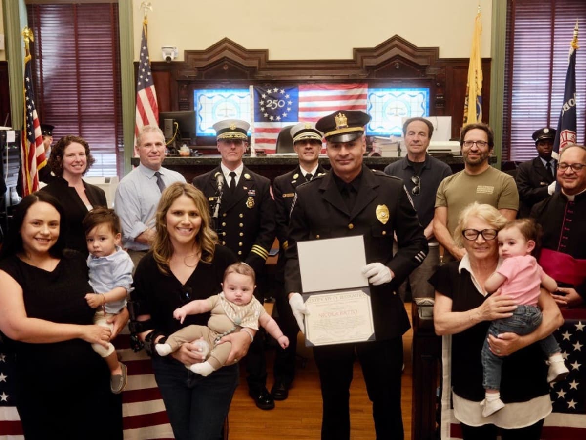 Hoboken firefighters in dress uniforms standing together during commendation ceremony honoring seventeen heroes
