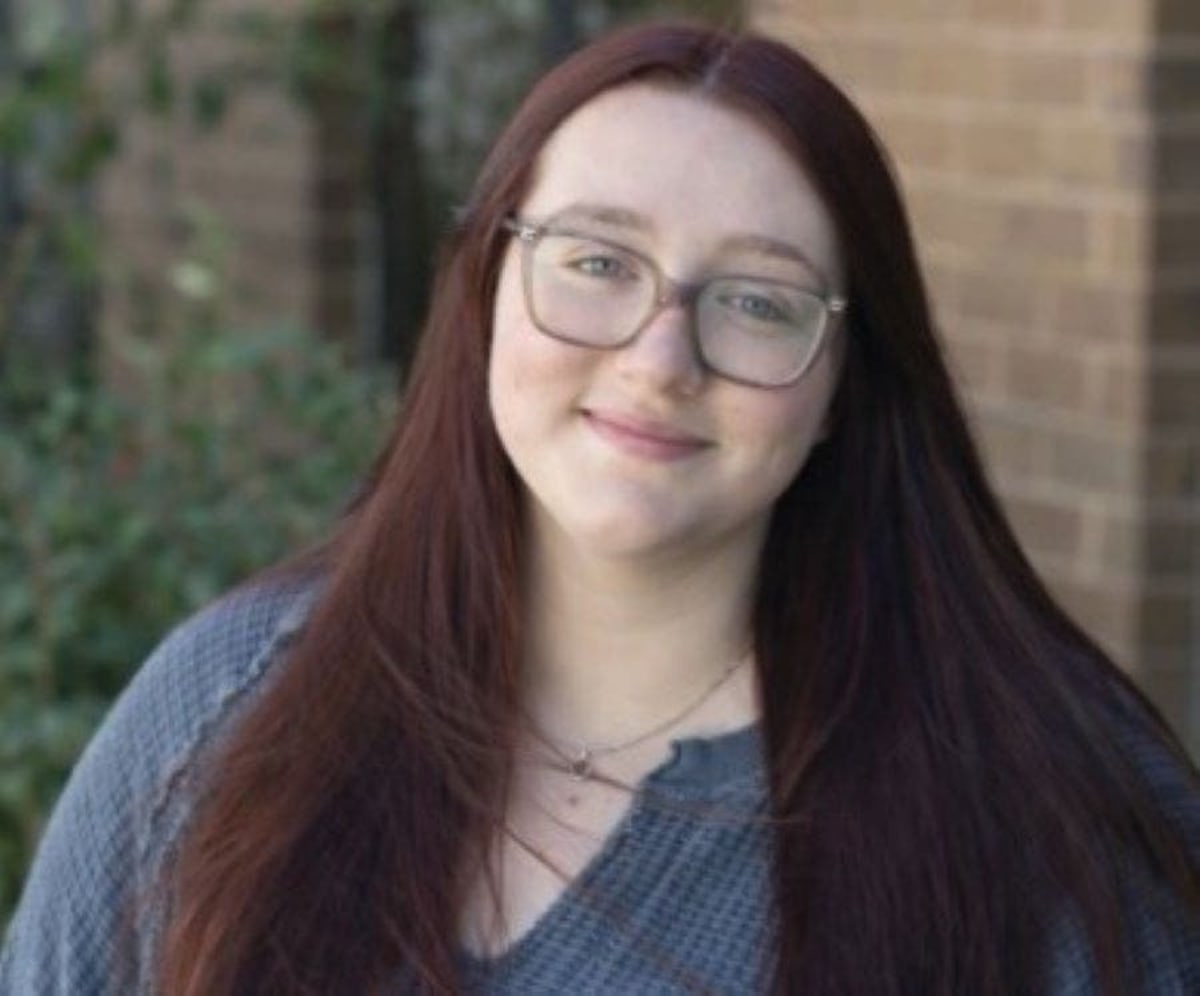 Emily Frame smiling at Newtown Discovery Preschool in Pennsylvania classroom with young students