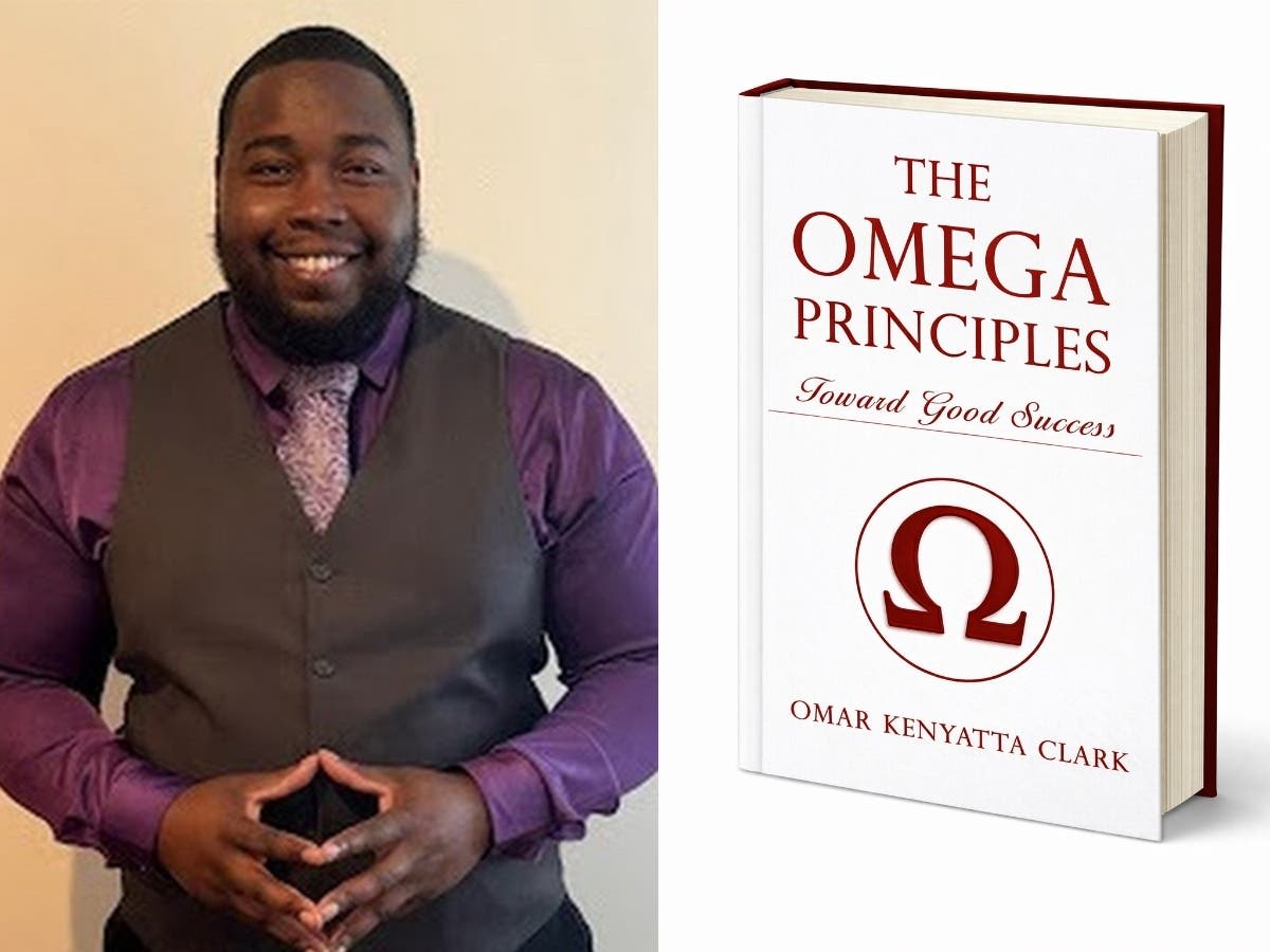 Omar Kenyatta Clark holding his book The Omega Principles about redefining success through mental health recovery