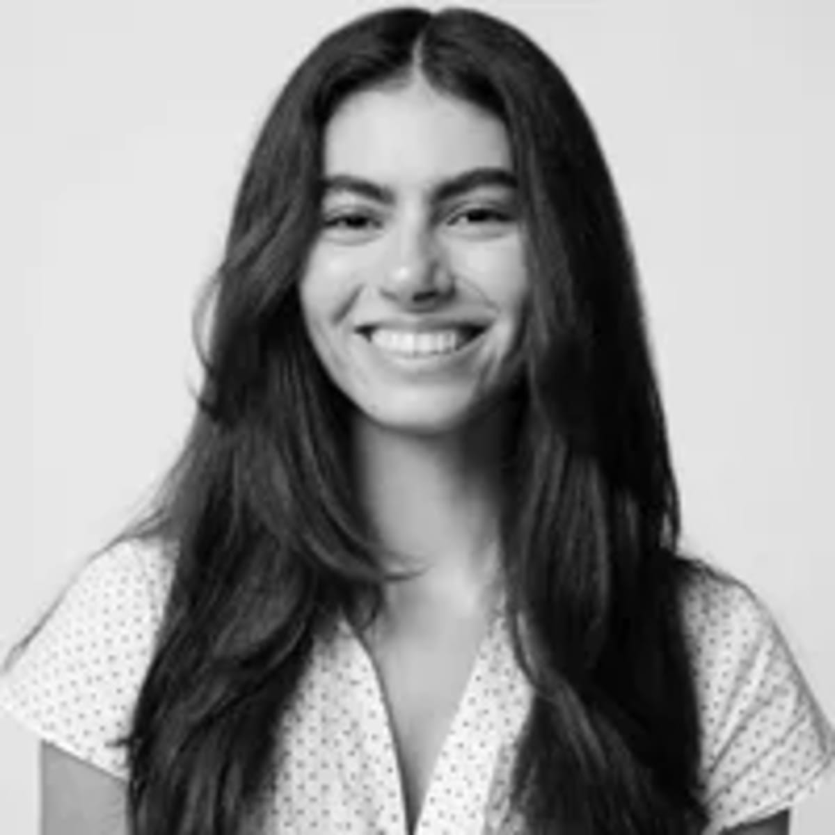 Bride in white wedding dress embracing her father during emotional first look moment outdoors