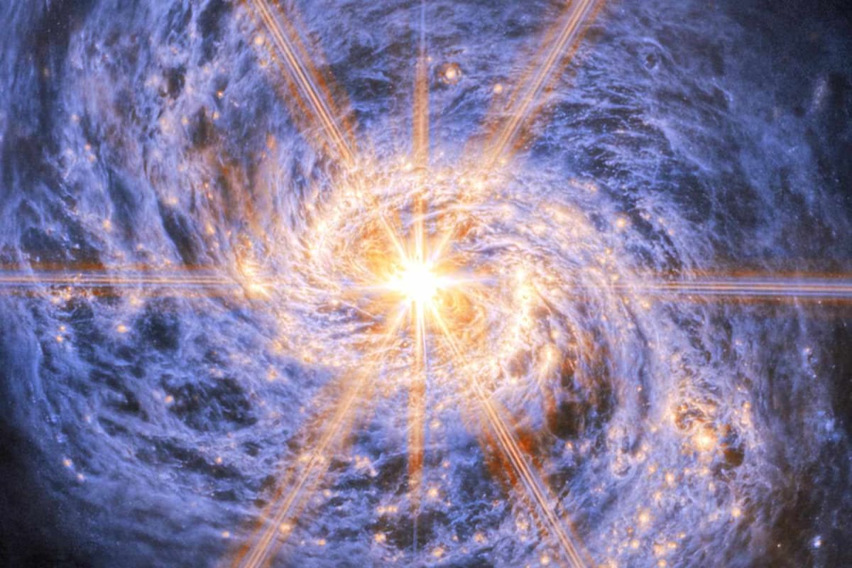 Infrared image of Messier 77 spiral galaxy showing bright center and curling tentacle-like arms