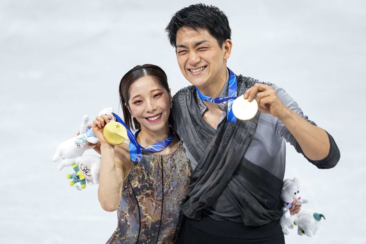 Japanese figure skaters Riku Miura and Ryuichi Kihara celebrating Olympic gold medal at Milan Cortina 2026