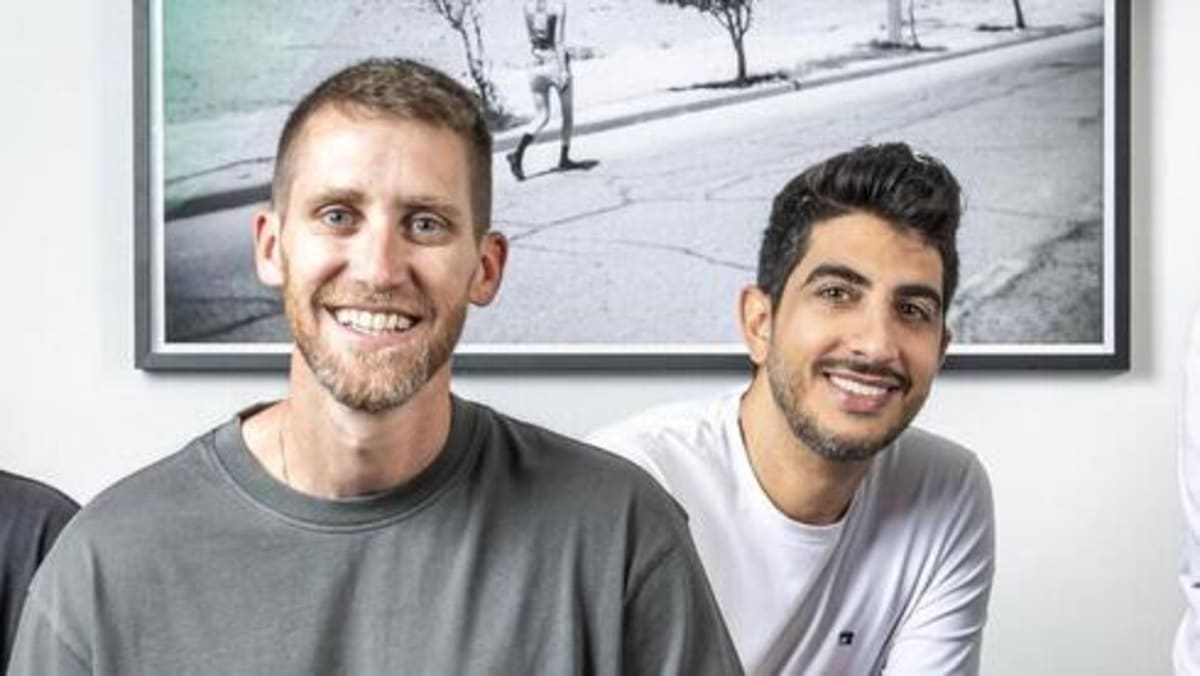 Wiz founders Assaf Rappaport and Yinon Costica standing together at company event