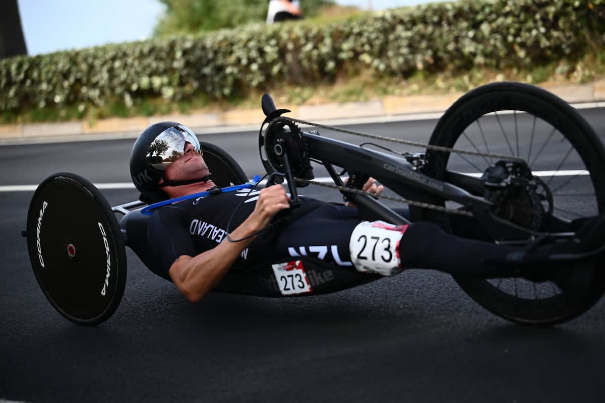Hand cyclist Rory Mead competing in racing position during World Cup event in Italy