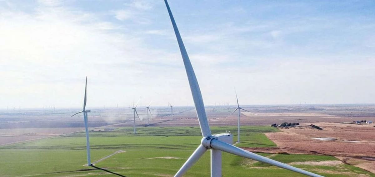 Wind turbines and solar panels across Swedish landscape generating clean renewable energy