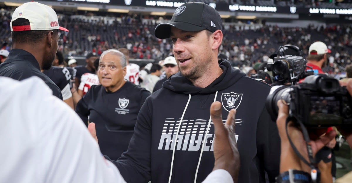 ** Las Vegas Raiders players celebrating on field after season opening victory over Miami Dolphins