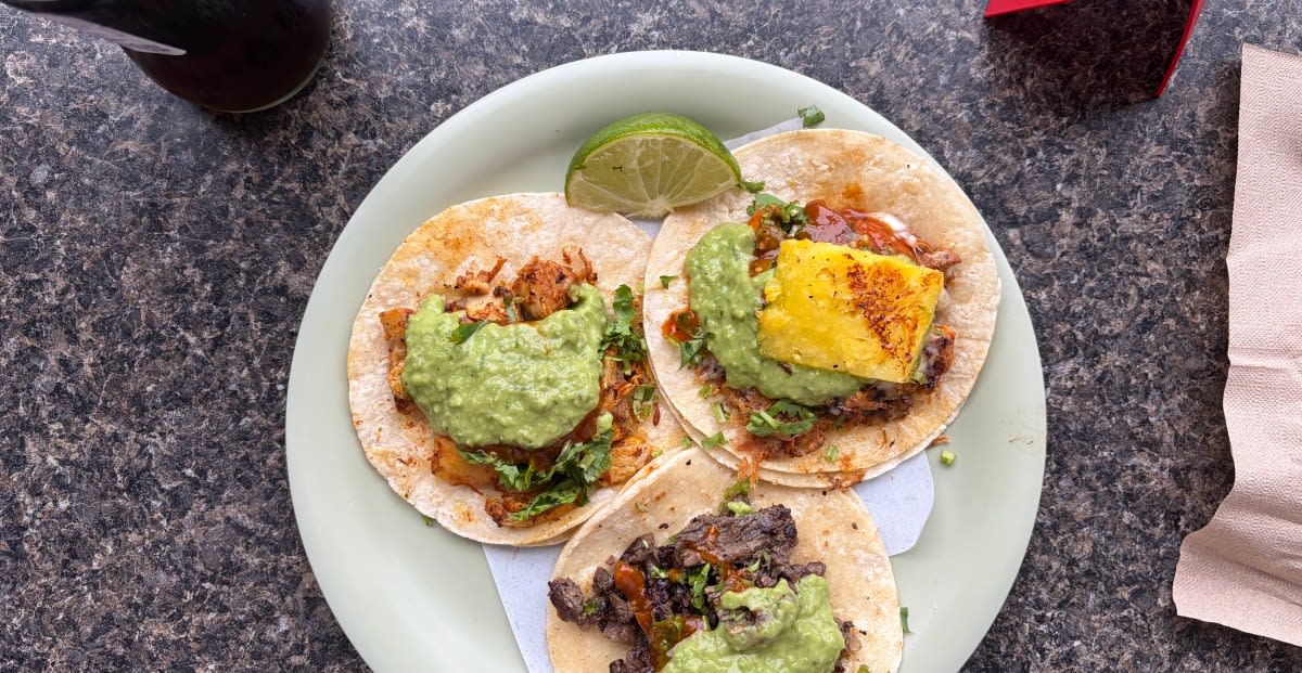 Person using smartphone with Google Maps displayed while exploring Seattle on rainy day