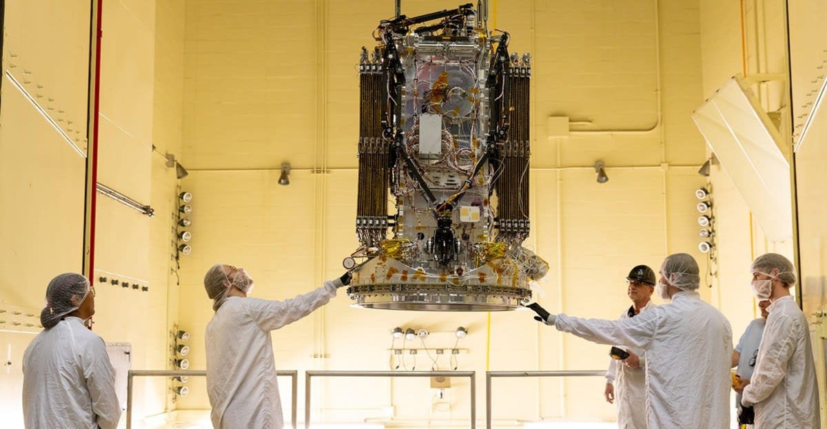 Engineers testing the Link rescue spacecraft with three robotic arms at NASA facility