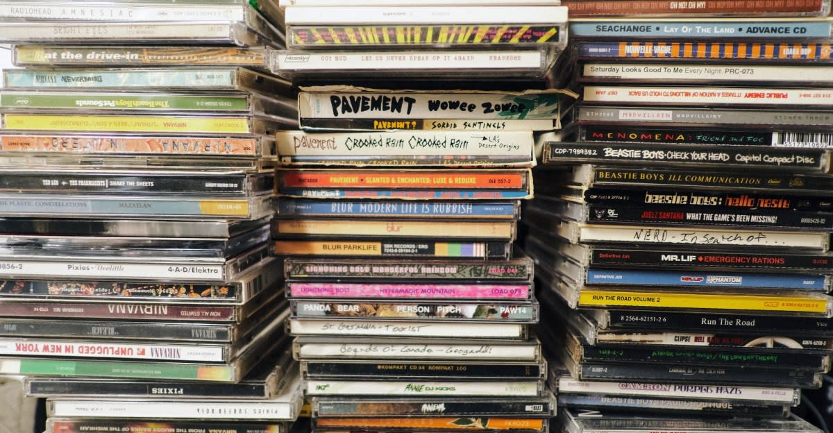 Collection of colorful music CDs stacked together showing physical media resurgence
