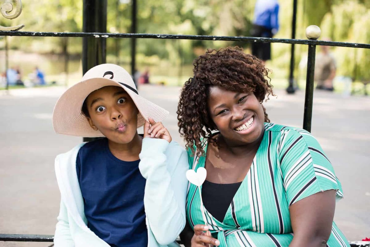 Young person smiling during mentoring session with adult volunteer from The Kids' Network