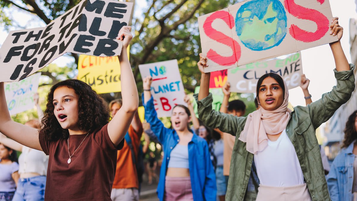 Students learning about renewable energy technology and climate solutions in modern classroom setting