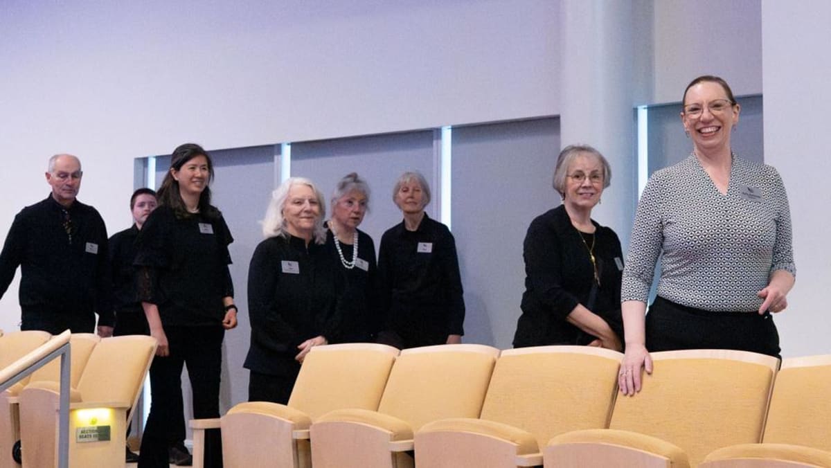 Audience services manager Kelly Kaiserian leads volunteers through Penn State's Recital Hall