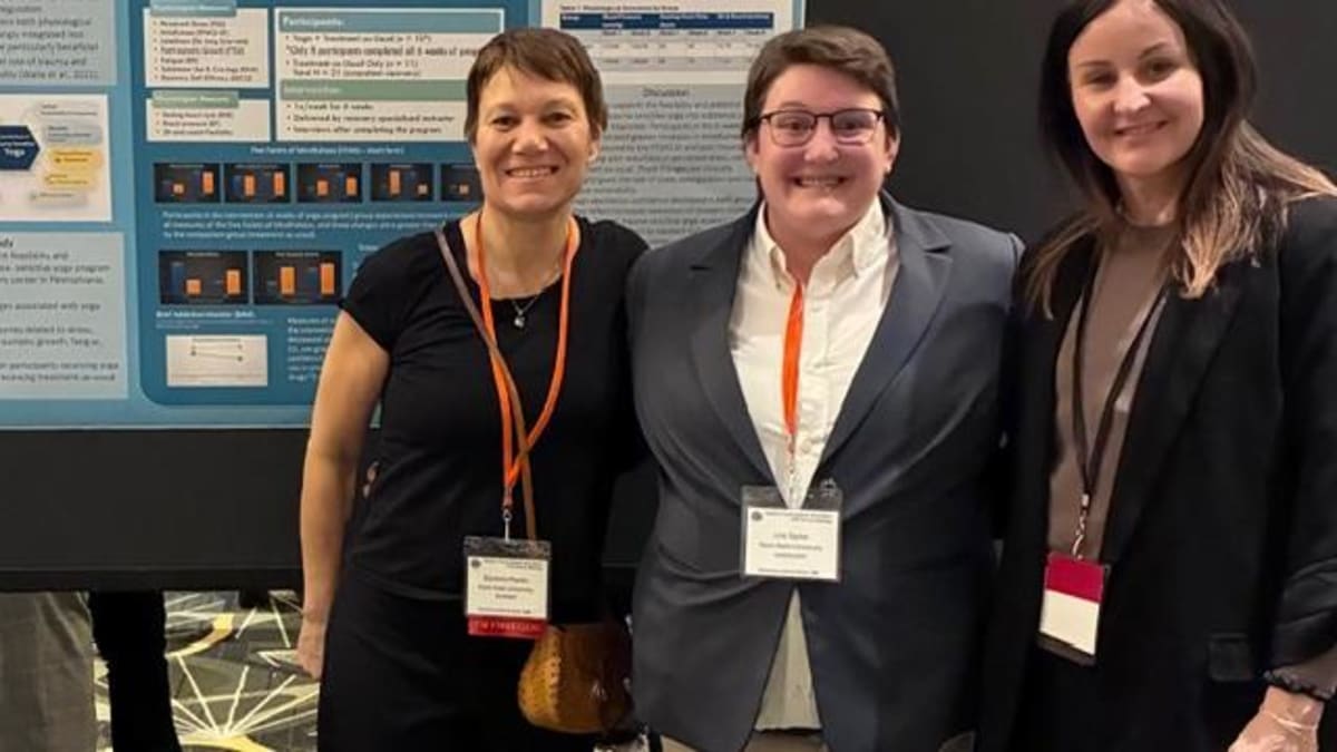 Three Penn State researchers presenting their yoga and addiction recovery study at conference