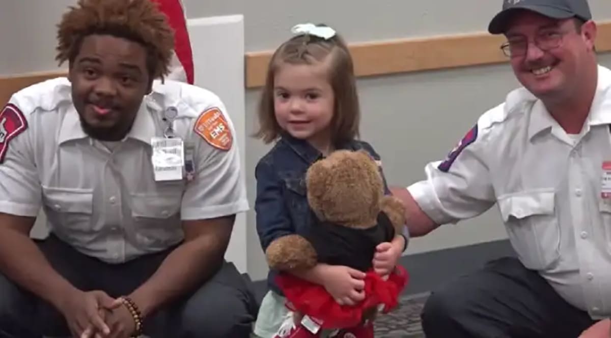 Three-year-old Noemi "Emi" Vatavuk smiling after being honored for saving her mother during seizure