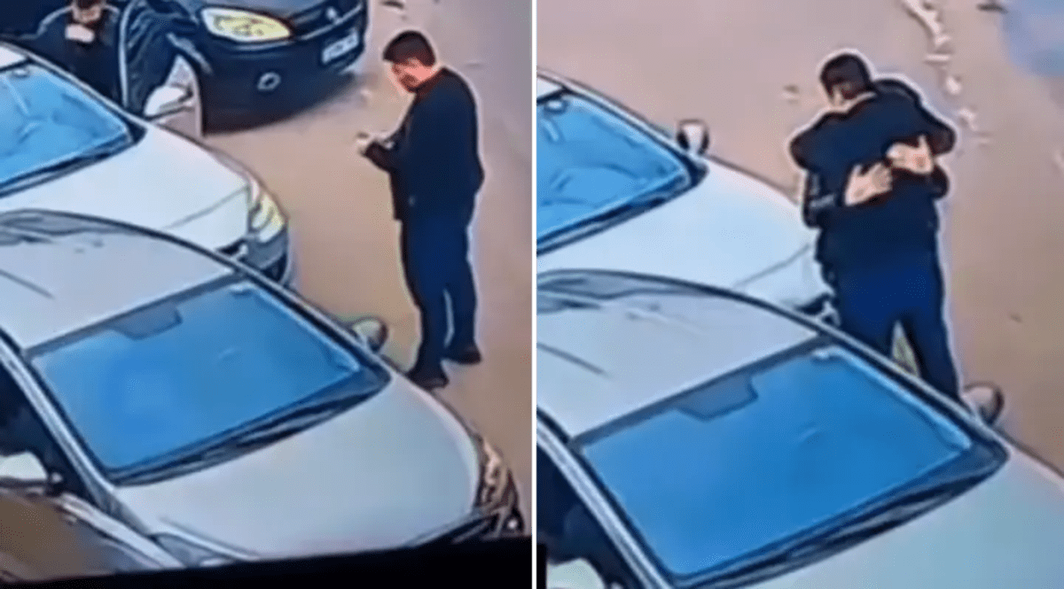 Security camera footage shows two men embracing on street after car accident in Brazil