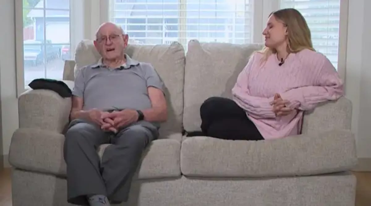 Elderly DoorDash driver Joe Symonds standing with Alyona Dikiy who started fundraiser for his retirement