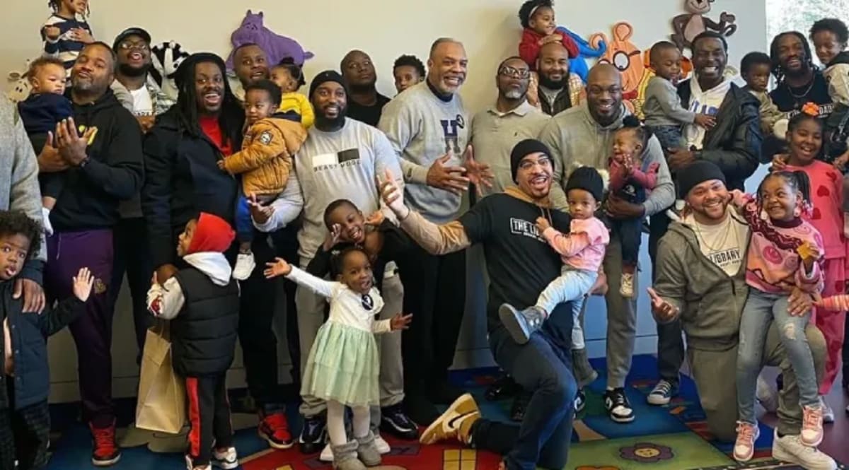 Group of fathers reading books with their young children at Atlanta public library