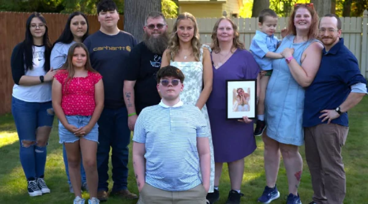 Mother embracing teenage organ recipient at graduation celebration honoring her late daughter Emily