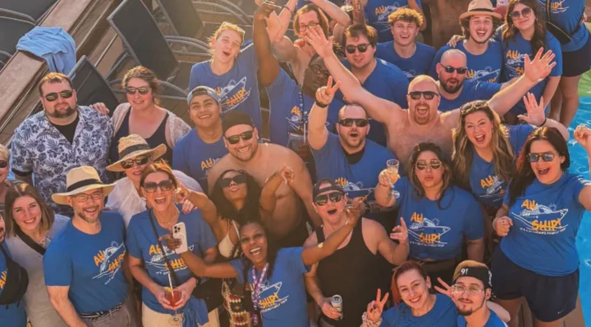 Restaurant employees smiling together on Royal Caribbean cruise ship deck during Bahamas trip