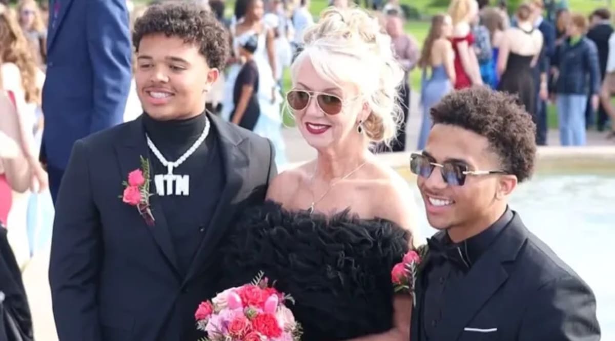 Teen Avant Williams poses with his grandmother Svala Heller before prom in formal attire