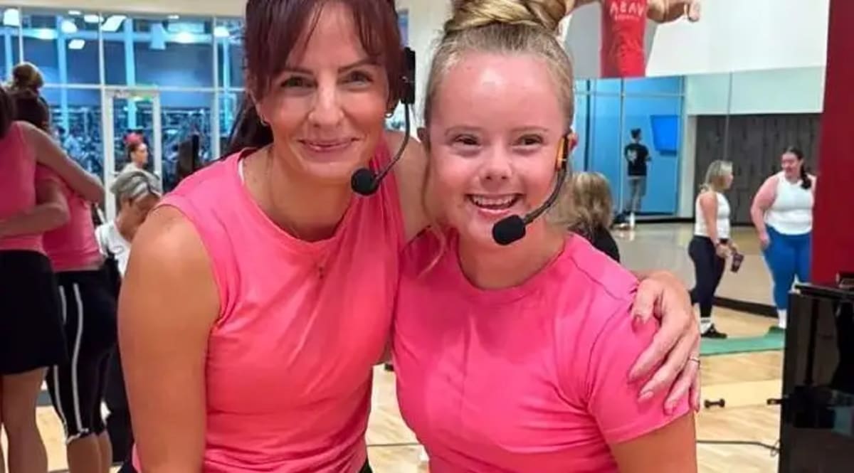 Aubry Alldredge smiling while teaching an UpBeat Barre fitness class with microphone headset