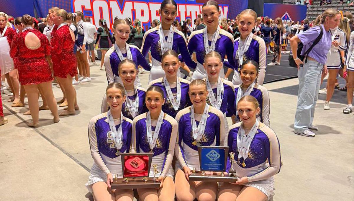 ** St. Aloysius Flashettes dance team of twelve girls posing with state championship trophy