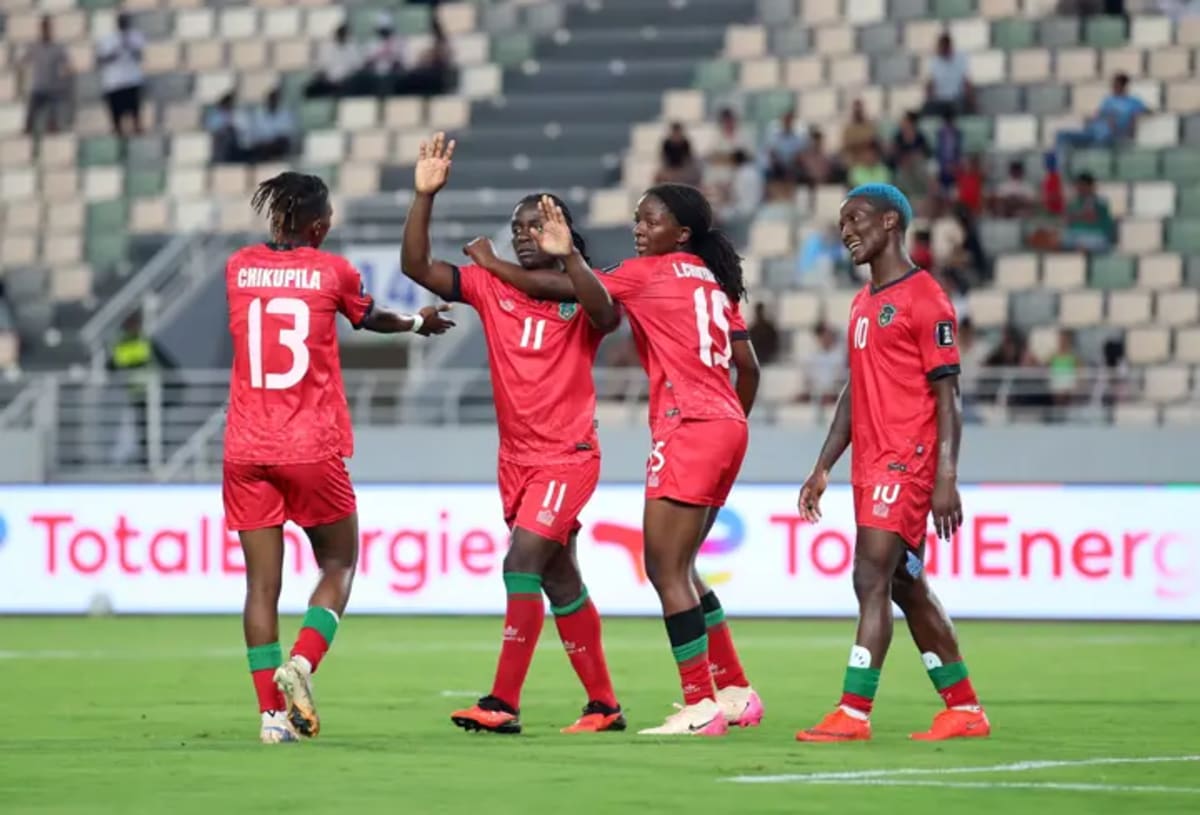 Tabitha and Temwa Chawinga celebrating together on football pitch in Malawi jerseys