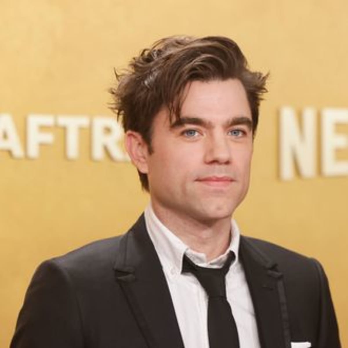 Actor Patrick Ball smiling at camera, star of medical drama The Pitt