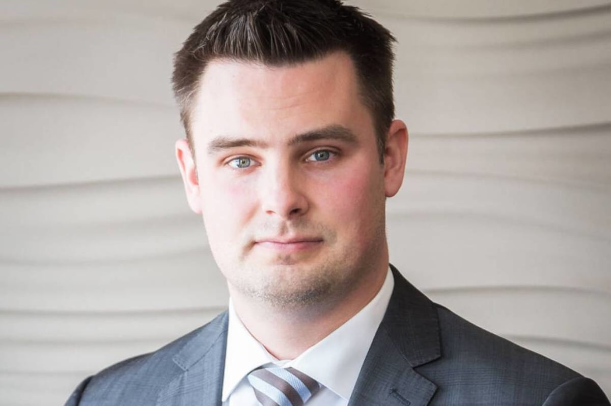 ** Joel McKay, Quesnel's city manager and horror fiction author, smiling in professional photo