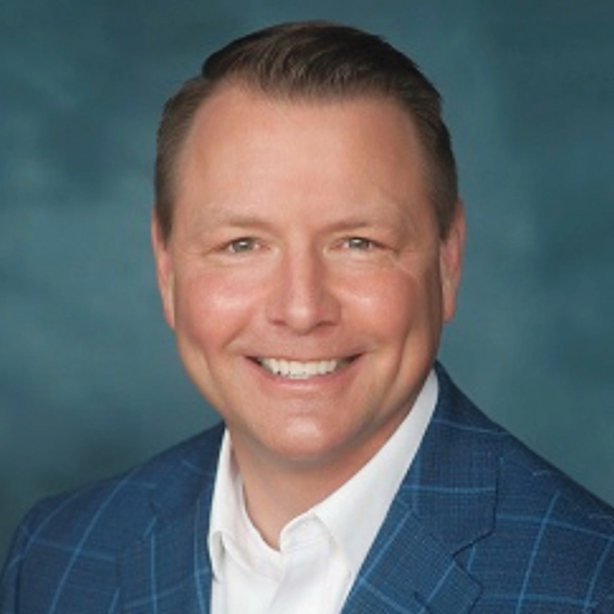 Matt Hurlbutt, president and CEO of Greater Rochester Enterprise, smiling professionally