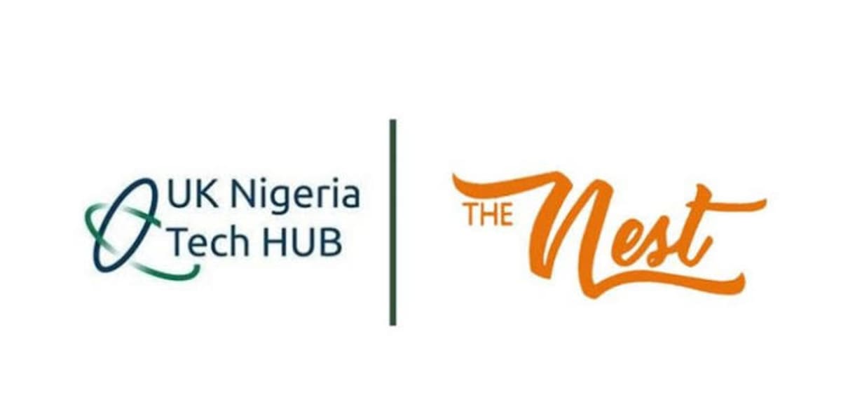 Nigerian tech entrepreneurs collaborating in modern innovation hub workspace with computers and digital displays