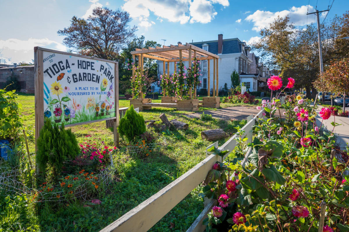 Volunteers planting flowers and adding soil to formerly vacant Philadelphia city lot