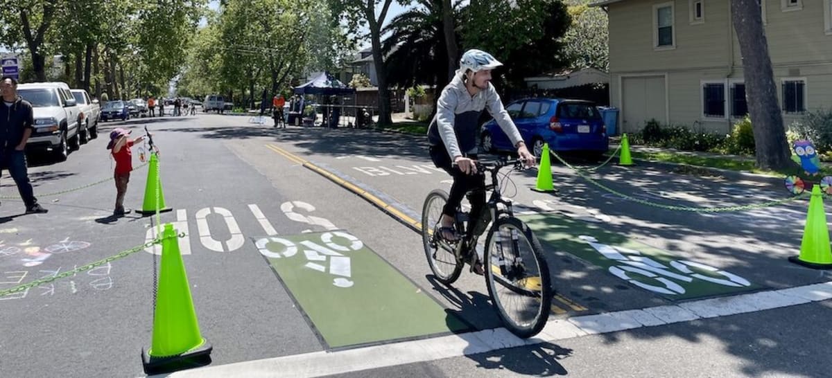 Cyclist receives free bike repair at outdoor station during Berkeley street safety block party