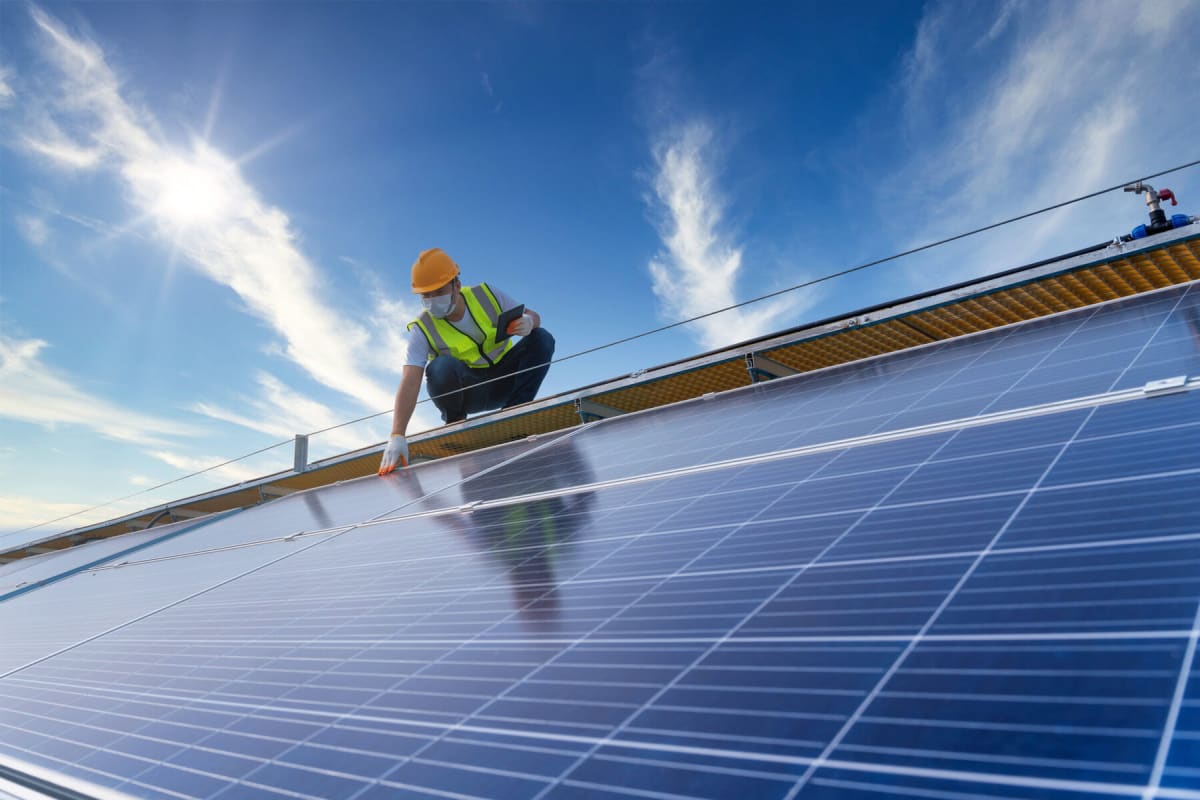 Modern banking building with solar panels installed on roof representing clean energy finance