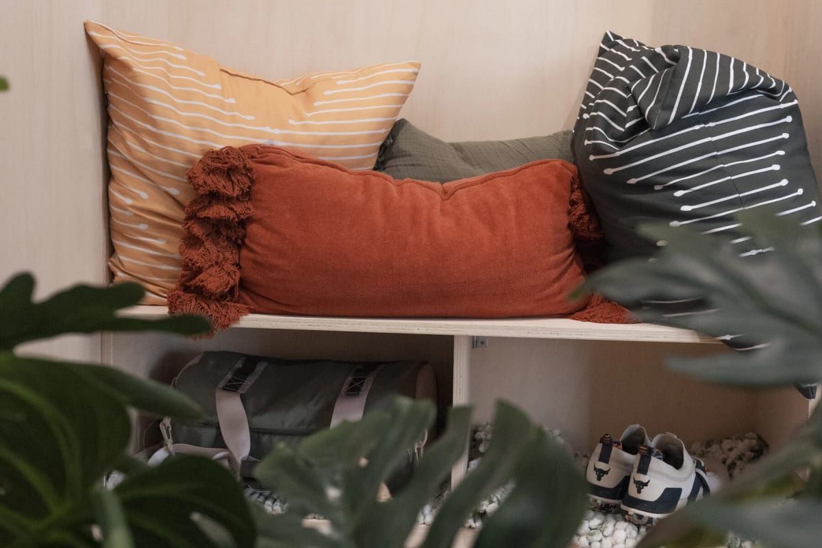 ** Minimalist wooden modular room with plants on shelves designed for formerly incarcerated people
