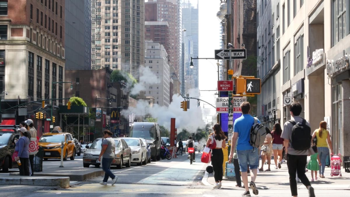 ** City street with traffic and buildings showing urban noise pollution sources