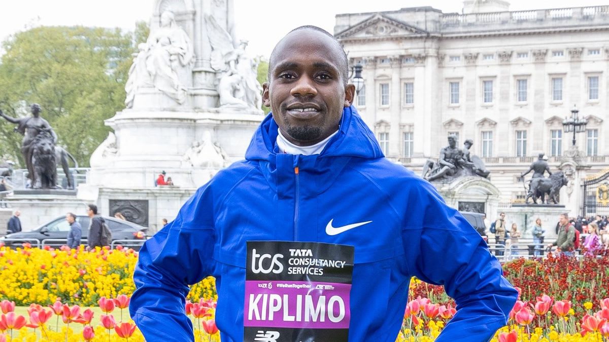 Jacob Kiplimo crossing finish line with arms raised in celebration at Lisbon half marathon