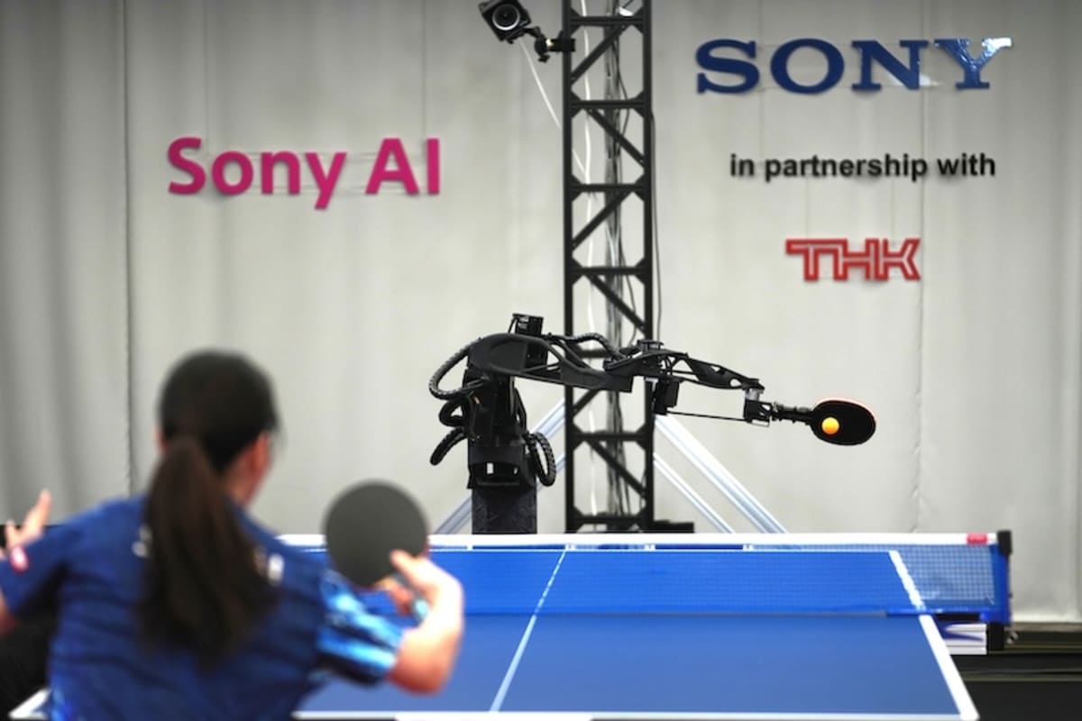 Sony's robotic arm holding table tennis paddle preparing to return ball during competitive match