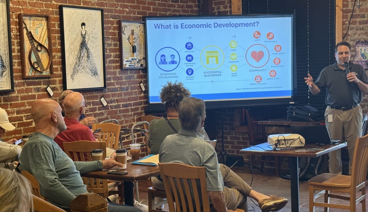 Norcross Economic Development Director David Versel speaking at community meeting about business support programs