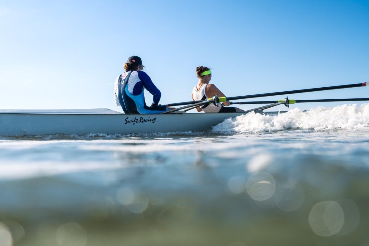 New Zealand rower Emma Twigg racing in beach sprint rowing competition on ocean water