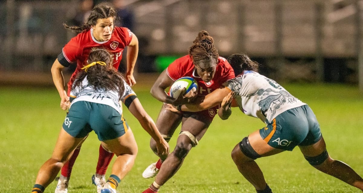 ** Canadian women's rugby players celebrating on wet field after shutout victory over Australia