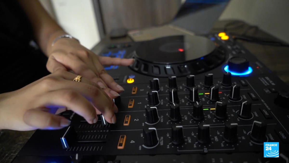 Female DJ performing at turntables in Pakistan's emerging underground music scene