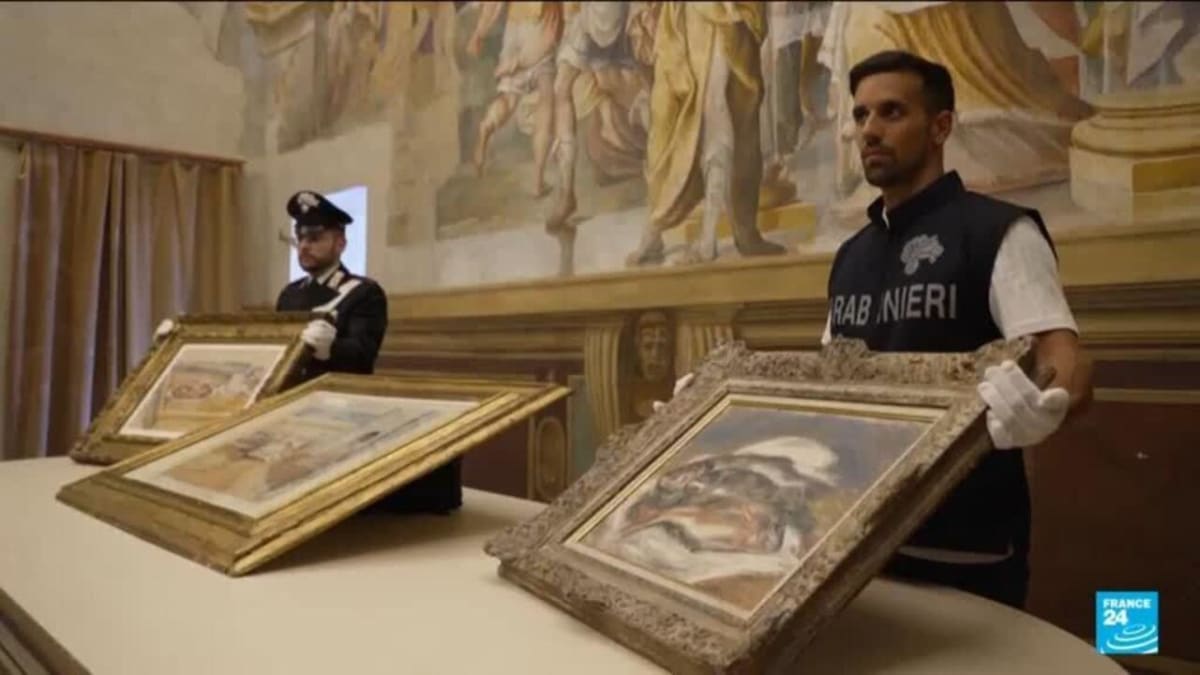 Italian police officers standing beside recovered masterpiece paintings by Renoir, Cézanne, and Matisse