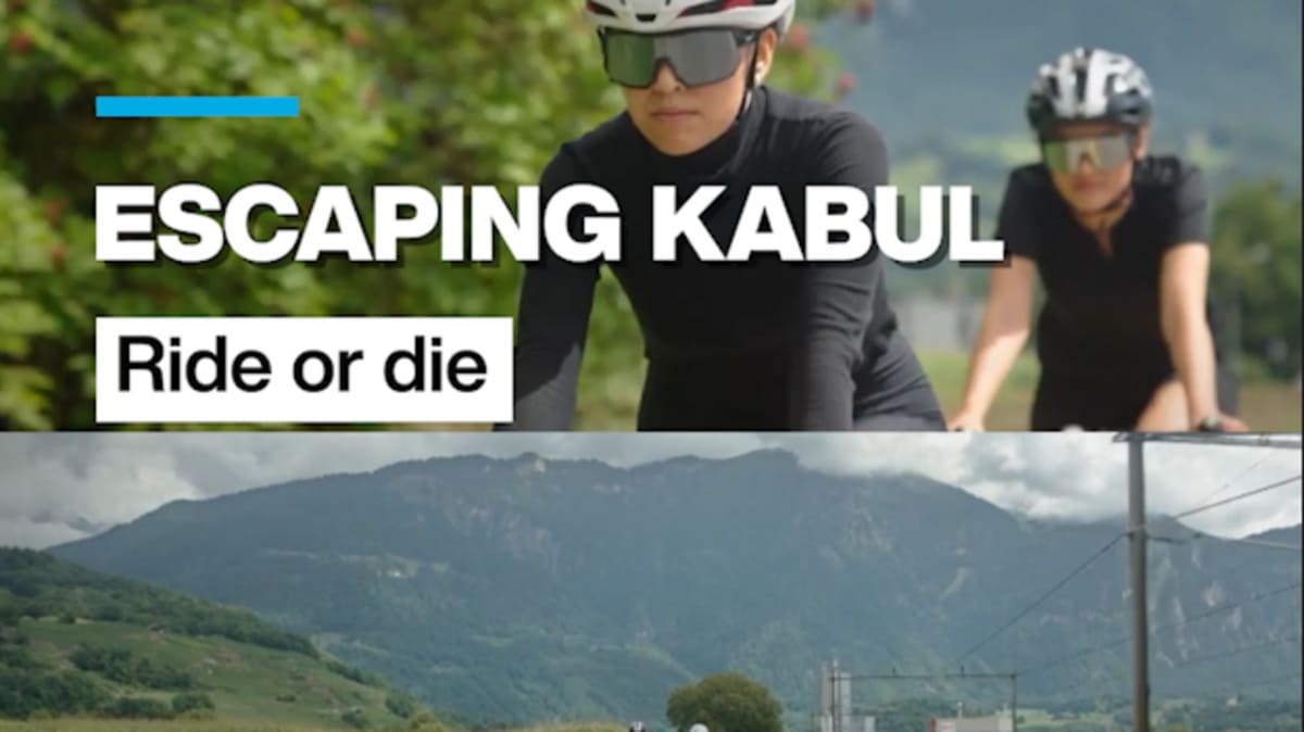 ** Afghan women cyclists racing on road bikes during international competition before Taliban takeover