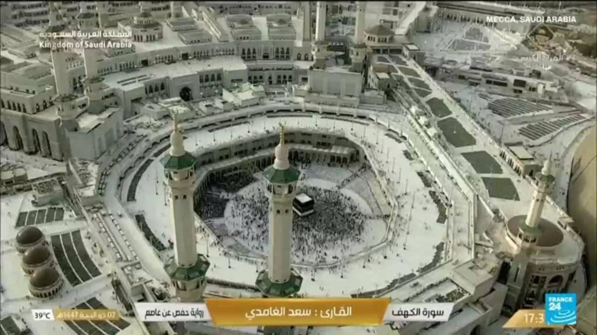 Large crowds of pilgrims in white garments gathering in Mecca for annual Hajj pilgrimage
