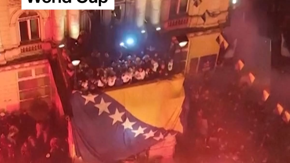 Thousands of Bosnian fans celebrate in crowded streets waving national flags after World Cup qualification