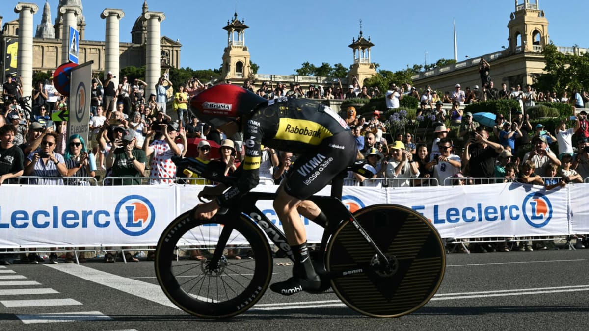 Danish cyclist Jonas Vingegaard racing past Barcelona's National Palace during Tour de France opening stage