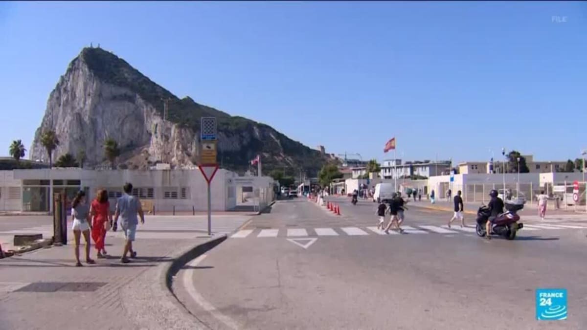 People crossing freely between Gibraltar and Spain where border fence once stood